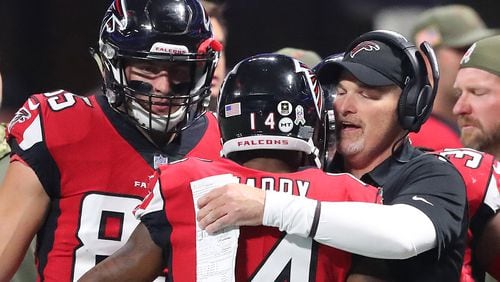 Falcons head coach Dan Quinn gives wide receiver Justin Hardy a hug after his touchdown reception against the Cowboys Sunday, Nov. 12, 2017, in Atlanta.
