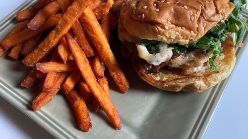 Boxcar’s Butchers Bun features shaved rib-eye, Swiss cheese, horseradish aioli and fried onions, and is served here with sweet potato fries. CONTRIBUTED BY BOB TOWNSEND