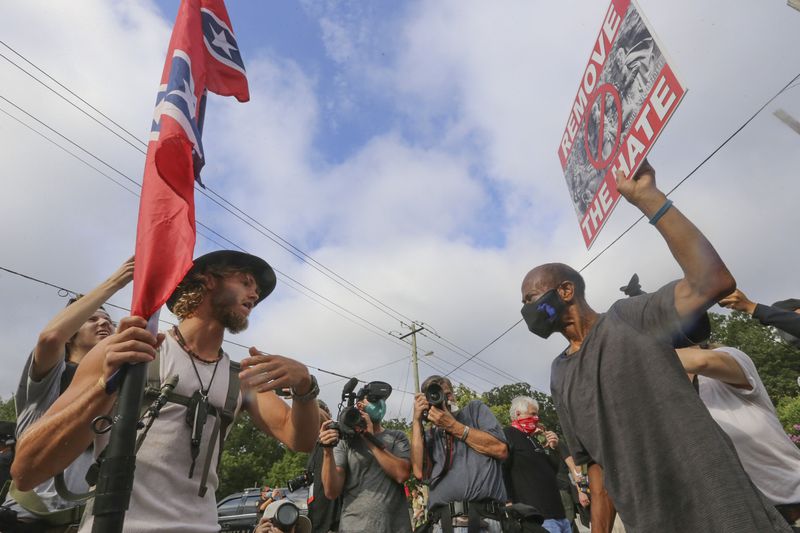 Counter-protesters face off with protesters as several far-right groups, including militias and white supremacists, rally Saturday, Aug. 15, 2020, in Stone Mountain while a broad coalition of leftist anti-racist groups organized a counter-demonstration. (Jenni Girtman/Atlanta Journal-Constitution/TNS)