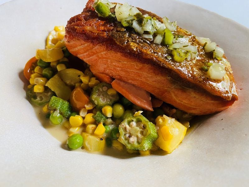 Leon’s steelhead trout plate features local summer squash, peas, heirloom tomatoes, corn, okra and jalapeño chimichurri. CONTRIBUTED BY BOB TOWNSEND