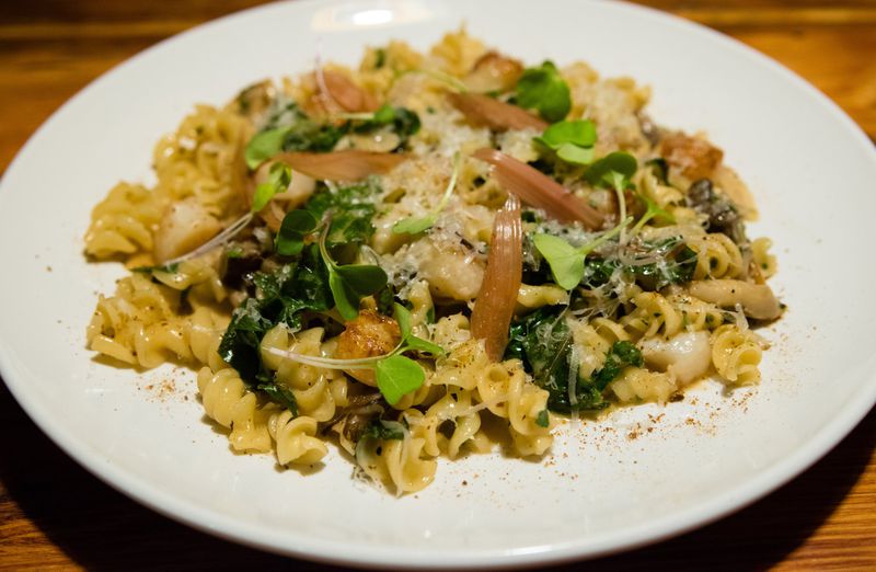At A Mano, this pasta course of fusilli is studded with late summer ingredients: diver scallops, mushrooms, rainbow chard and cream. CONTRIBUTED BY HENRI HOLLIS