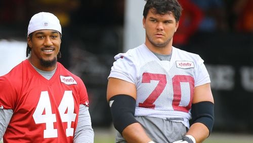 Falcons first round draft picks Vic Beasley Jr. (left) and Jake Matthews (right) take the field for team practice on Wednesday, Aug. 19, 2015, in Flowery Branch.
