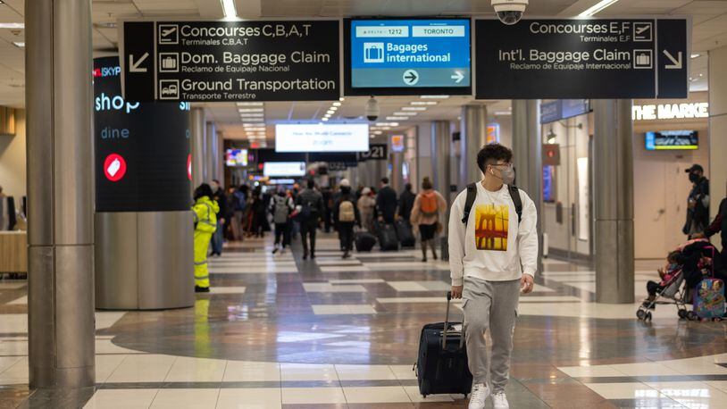 Travelers are seen moving through Hartsfield Jackson International Airport in Atlanta, Georgia on January 16th, 2022.