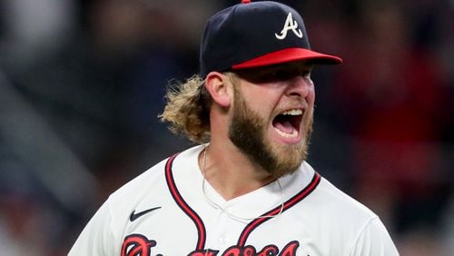 Braves reliever A.J. Minter reacts after striking out Los Angeles Dodgers catcher Will Smith in the sixth inning of Game 6 of the NLCS Saturday, Oct. 23, 2021, at Truist Park in Atlanta. (Curtis Compton / curtis.compton@ajc.com)