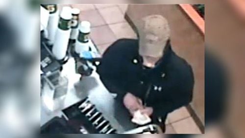 Surveillance footage shows a man taking cash from a Subway restaurant in Woodstock during a robbery on New Year's Day.