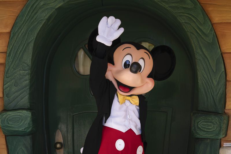 FILE - Mickey Mouse interacts with guests at Disneyland in Anaheim, Calif., Friday, April 30, 2021. Workers who help bring Disneyland's beloved characters to life said Wednesday, April 17, 2024, they have collected enough signatures to support their push for a union. (AP Photo/Jae C. Hong, File)