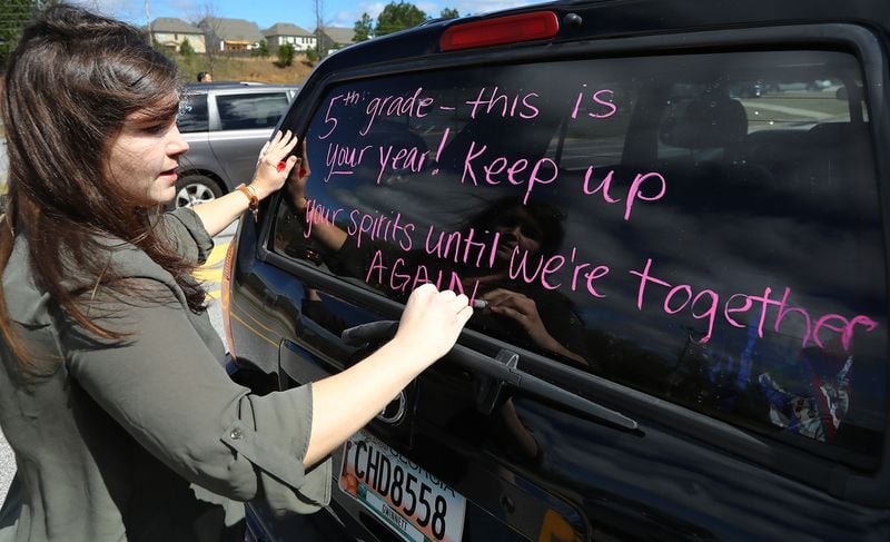 In this file photo, fifth-grade teacher Kirsten Zingleman decorates her vehicle in March. Curtis Compton ccompton@ajc.com