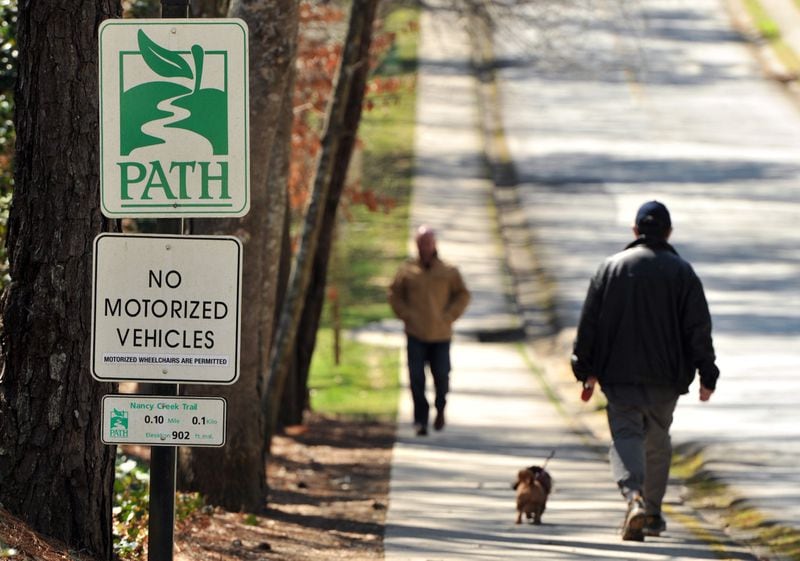 FILE PHOTO: Pedestrians walk along the Nancy Creek Trail. The PATH Foundation launched a free app that lets outdoor enthusiasts explore PATH trails using their mobile devices. The app provides on-the-go GPS directions and general information about PATH’s network of pathways throughout Atlanta, along with local weather forecasts and news articles. HYOSUB SHIN / HSHIN@AJC.COM