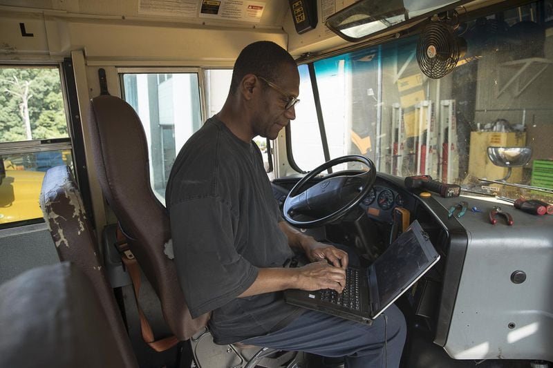Alonzo Roberson runs a diagnostic on a school bus at the Atlanta Public Schools Transportation hub in Atlanta’s Sylvan Hills community, Friday, May 31, 2019. (Alyssa Pointer/alyssa.pointer@ajc.com)