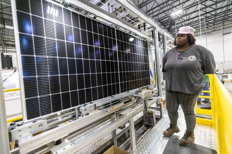 Janiece Beeman performs one of the last visual inspections of a solar panel as it moves through an automated assembly line at the Qcells module production facility in Cartersville on Tuesday, April 2, 2024. (Steve Schaefer/steve.schaefer@ajc.com)