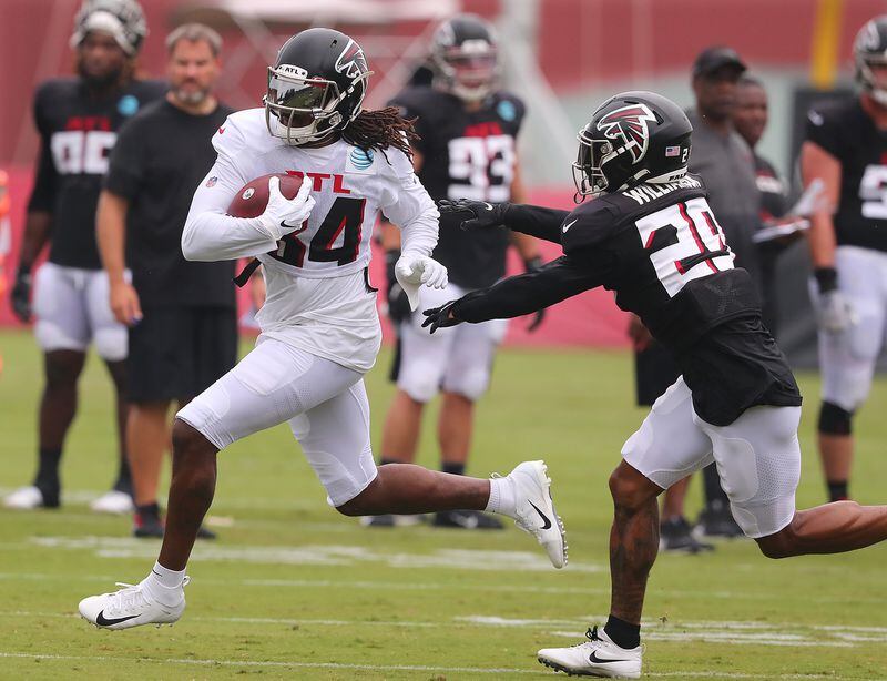 Falcons running back Cordarrelle Patterson runs for yardage after the catch with cornerback Chris Williamson moving in for the stop during the first day in pads at training camp Tuesday, Aug. 3, 2021, in Flowery Branch. (Curtis Compton / Curtis.Compton@ajc.com)