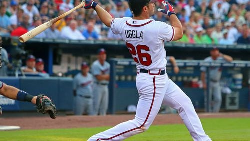 Atlanta's Dan Uggla hits a three-run homer for an early 4-0 lead over the Twins in the first inning.