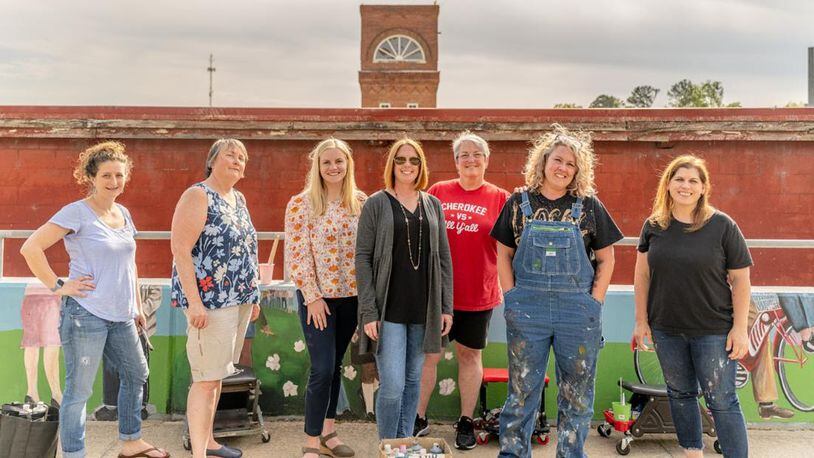 Cherokee High School teacher Shanna Coulter (second from right) was the lead artist on the Canton mural. Brooke Schmidt, Canton City Councilor (Ward 3) (center) helped coordinate along with several other volunteers. Photo by Bronson Kurtz