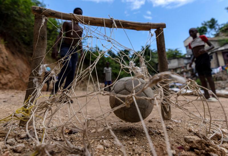 Youths play soccer in the Petion-Ville neighborhood of Port-au-Prince, Haiti, Sunday, April 21, 2024. (AP Photo/Ramon Espinosa)