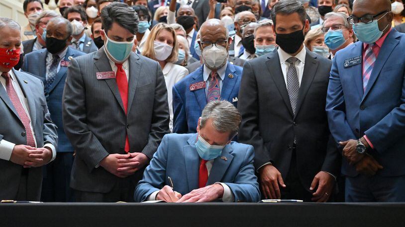 Gov. Brian Kemp signs into law House Bill 426 on the last day of this year’s legislative session. The new law, which took effect Wednesday, is Georgia’s first hate-crimes law in 16 years. (Hyosub Shin / Hyosub.Shin@ajc.com)