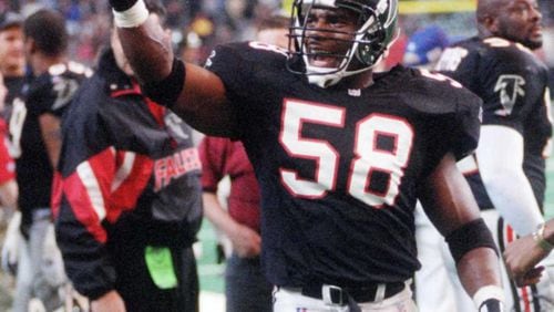 Falcons linebacker Jessie Tuggle points to the crowd after coming up with a huge interception in 1995. (AJC file photo)