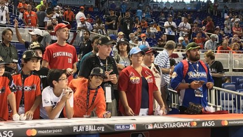 Fans wait for autographs above the American League dugout before the Major League Baseball All-Star Game at Marlins Park on Tuesday.