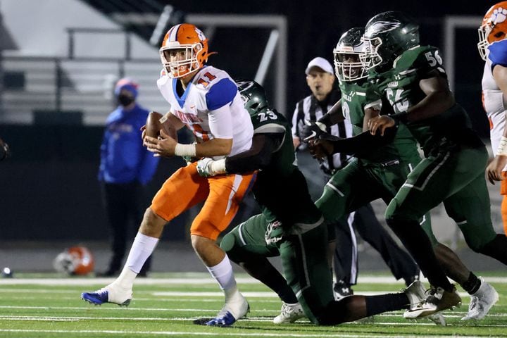 Dec. 11, 2020 - Suwanee, Ga: Parkview quarterback Colin Houck (11) is stopped by Collins Hill defensive lineman Asani Redwood (23) and teammates on ParkviewÕs final offensive play on a 4th down attempt in the second half at Collins Hill high school Friday, December 11, 2020 in Suwanee, Ga.. Collins Hill defeated Parkview 21-14 to advance to the Class AAAAAAA semi-finals next week. JASON GETZ FOR THE ATLANTA JOURNAL-CONSTITUTION