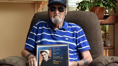 Jeff Settle served in the Navy during WW II. Settle received the Purple Heart after when he was injured during a bombing. Shown August 20, 2015 at his Marietta home.