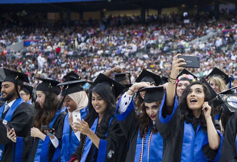 Georgia State University undergraduate students take part in the 2018 commencement ceremony. AJC FILE PHOTO / REANN HUBER 2018