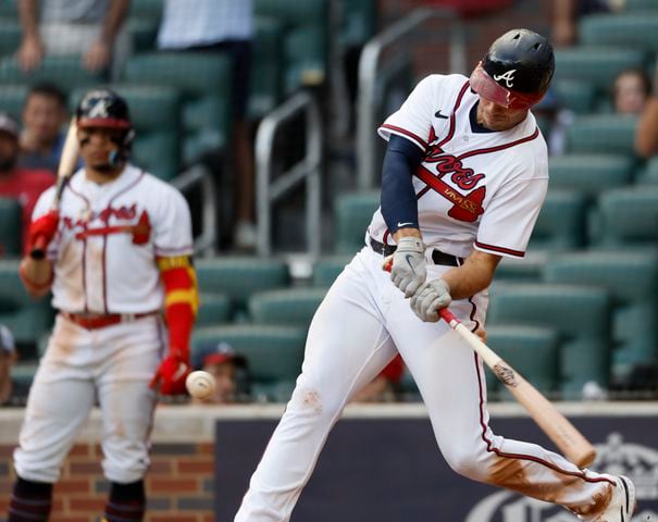 Atlanta Braves' Matt Olson hits a three run homer during the ninth inning of game one of the baseball playoff series between the Braves and the Phillies at Truist Park in Atlanta on Tuesday, October 11, 2022. (Jason Getz / Jason.Getz@ajc.com)
