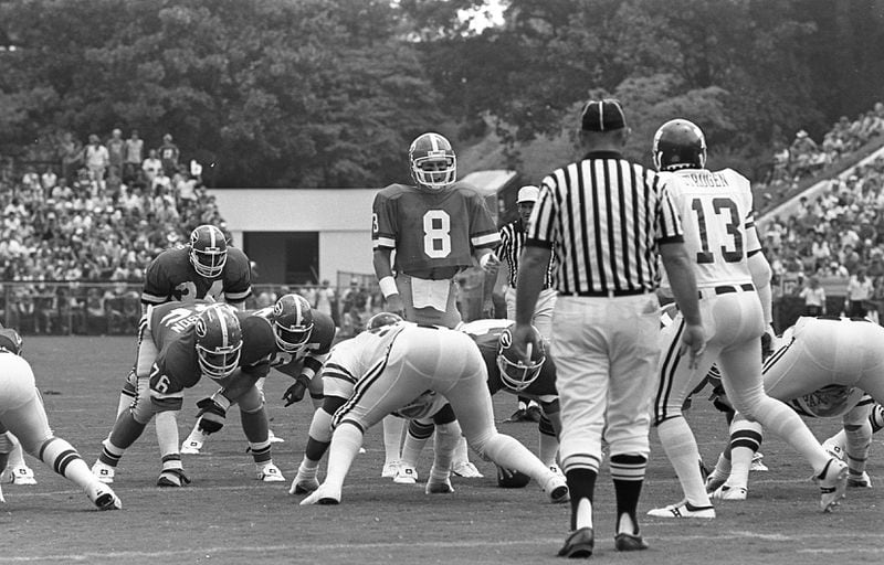 QB Buck Belue (8) has the UGA offense at the line against Texas A&M in 1980. Herschel Walker waits behind him for the play to start. AJC file photo