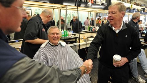 110108 Atlanta: U.S Senator Johnny Isakson, right shakes hands with a patron as Governor elect Nathan Deal gets a hair cut from Thomas Barber Shop owner, Tommy Thomas Saturday January 8, 2011. Brant Sanderlin bsanderlin@ajc.com