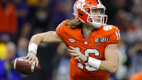 FILE - Clemson quarterback Trevor Lawrence passes against LSU during the second half of a NCAA College Football Playoff national championship game in New Orleans, in this Monday, Jan. 13, 2020, file photo.  Ohio State quarterback Justin Fields was among 98 juniors granted eligibility by the NFL into the draft, while national championship-winning QBs Mac Jones from Alabama and Trevor Lawrence from Clemson were among another 30 players eligible after completing their degrees and deciding not to play more in college. (AP Photo/Gerald Herbert, File)