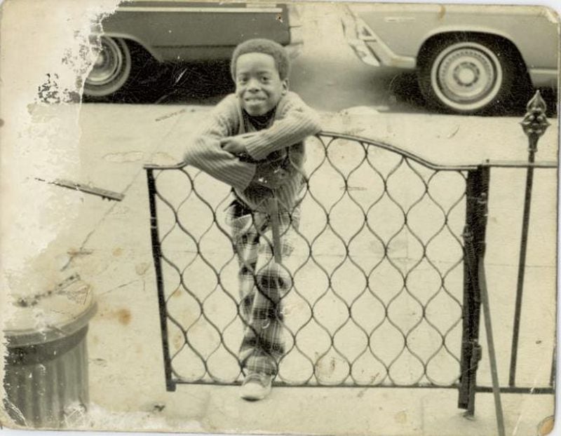 Atlanta Journal-Constitution reporter Ernie Suggs in front of a Brooklyn brownstone circa 1973, when he would have been about 6 years old. (Courtesy of Ernie Suggs)