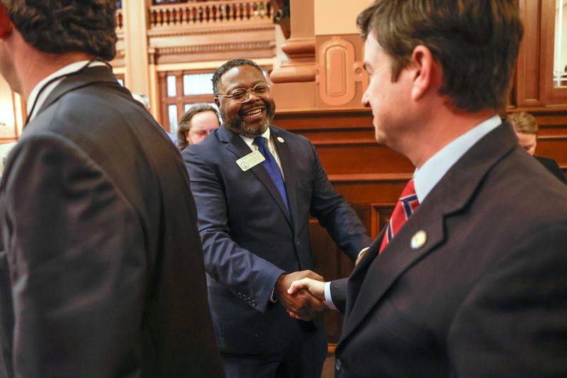 (Left to right) Rep. Teddy Reese, D-Columbus, greets Sen. Matt Brass, R-Newnan, as he walks into House chambers with other senators for the annual state of the judiciary address on Wednesday, Feb. 7, 2024. (Natrice Miller/natrice.miller@ajc.com)
