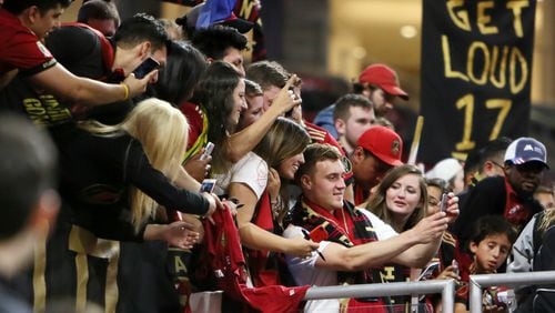 April 7, 2018.  Atlanta United midfielder Julian Gressel takes selfies with fans, he was name best player of the match after scoring a goal and one assist.