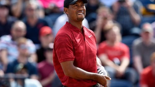 Tiger Woods reacts after playing his shot from the third tee during the final round of The Open Championship golf tournament at Carnoustie Golf Links.