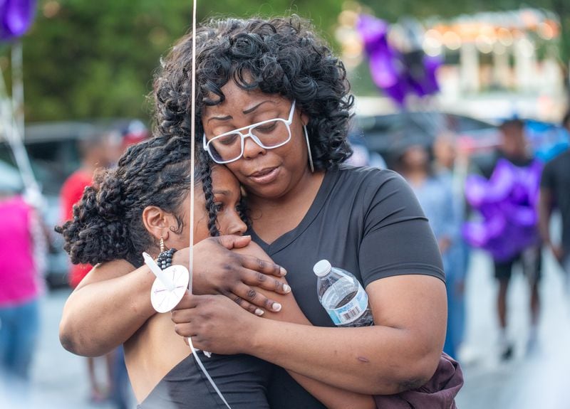 Jacob Johnson's girlfriend, Madeline Cubas, and his mother, Tia Morgan,  share a hug.
