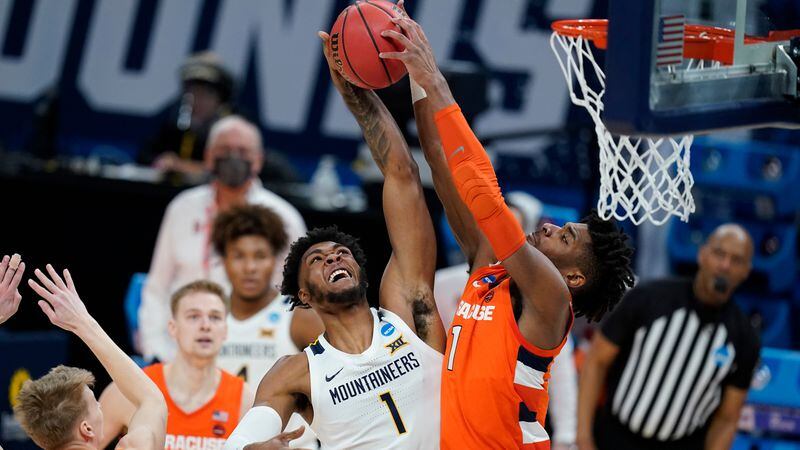 West Virginia's Derek Culver (1) has his shot blocked by Syracuse's Quincy Guerrier (1) during the first half of their second-round game in the NCAA Tournament Sunday, March 21, 2021, at Bankers Life Fieldhouse in Indianapolis. (Darron Cummings/AP)
