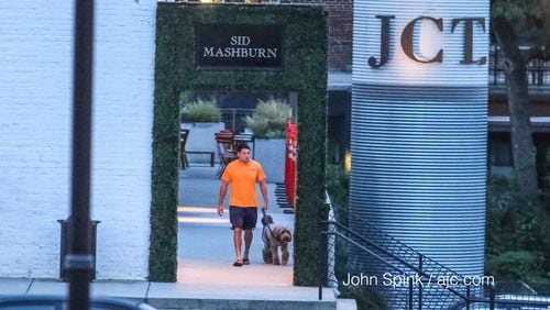 A man was seen walking outside JCT Kitchen & Bar Tuesday morning. Late Monday, a robber shot a man in the parking lot, chased him inside the popular Midtown restaurant and continued firing, Atlanta police said. JOHN SPINK / JSPINK@AJC.COM