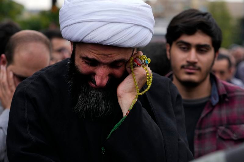 A cleric weeps during a mourning ceremony for Iranian President Ebrahim Raisi at Vali-e-Asr square in downtown Tehran, Iran, Monday, May 20, 2024. President Raisi and the country's foreign minister were found dead Monday hours after their helicopter crashed in fog, leaving the Islamic Republic without two key leaders as extraordinary tensions grip the wider Middle East. (AP Photo/Vahid Salemi)