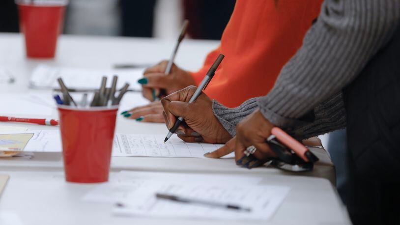 Members of the Mableton community sign petitions following the town hall discussion about the process to de-annex from the city on Wednesday, January 18, 2023.  (Natrice Miller/natrice.miller@ajc.com) 