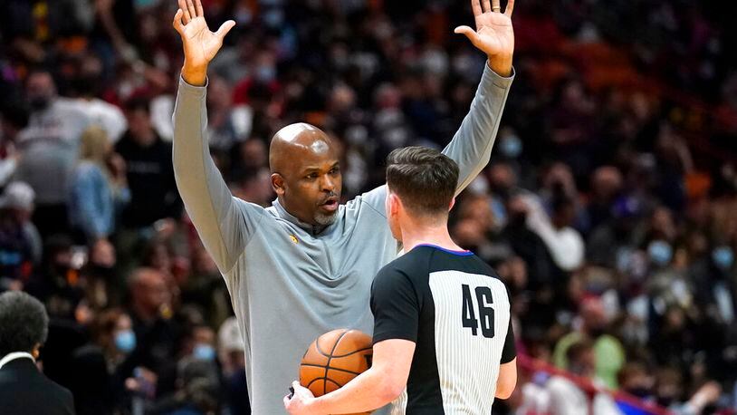 Atlanta Hawks head coach Nate McMillan, left, argues a call with official Ben Taylor (46) during the first half of an NBA basketball game against the Miami Heat, Friday, Jan. 14, 2022, in Miami. (AP Photo/Lynne Sladky)
