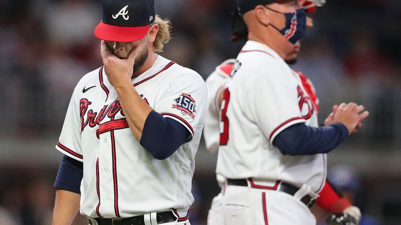 Braves pitcher A.J. Minter reacts as manager Brian Snitker pulls him during the eighth inning against the Toronto Blue Jays after he loaded the bases and gave up a RBI single Tuesday, May 11, 2021, in Atlanta.    “Curtis Compton / Curtis.Compton@ajc.com”