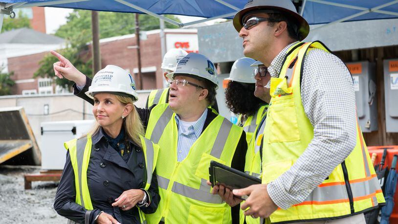 Louise Samsky (from left), Brett Samsky and Connor Samsky with David Hajjar, senior project manager for Brasfield & Gorrie, on-site at the Piedmont Atlanta Tower under construction. CONTRIBUTED