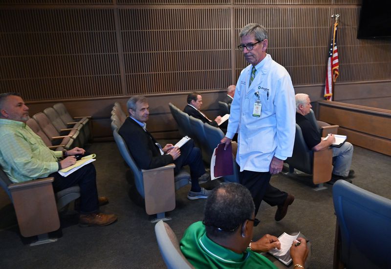 Steven Kitchen, chief medical officer at Phoebe Putney Memorial Hospital, returns to his seat after giving a community update at Albany’s daily Facebook Live briefing on Tuesday. Kitchen said he was summoned to the hospital shortly before midnight Monday to help make decisions on which patients to move out of intensive care in order to make room for rapidly deteriorating patients who needed beds. HYOSUB SHIN / HYOSUB.SHIN@AJC.COM