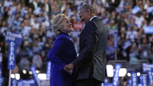 President Barack Obama, right, talks with Democratic presidential candidate Hillary Clinton, left, following Obama's speech at the Democratic National Convention in Philadelphia on Wednesday. (AP/Susan Walsh)