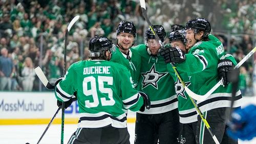 Dallas Stars players celebrate a goal by Joe Pavelski, center, during the first period in Game 5 of an NHL hockey Stanley Cup second-round playoff series against the Colorado Avalanche, Wednesday, May 15, 2024, in Dallas. (AP Photo/Tony Gutierrez)