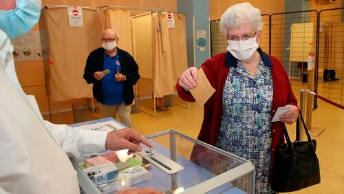 A woman casts a vote  during the second round of  municipal elections in France.