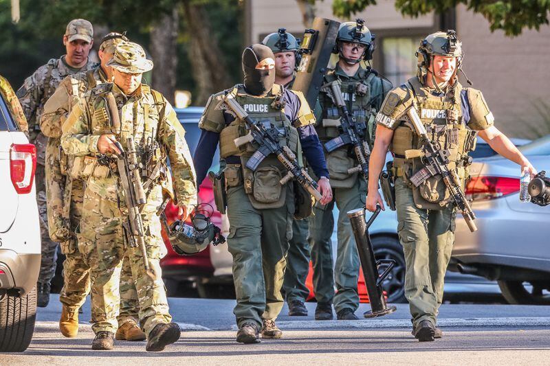 SWAT officers were deployed to a Gwinnett County apartment Thursday morning after a man barricaded himself inside one of the units. JOHN SPINK / JSPINK@AJC.COM