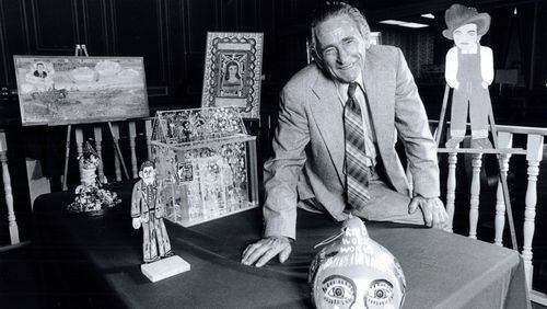 In this 1985 file photo, Howard Finster was shown with his folk art, which was on display in the National Bank of Chattooga County in Summerville. (AJC file photo)