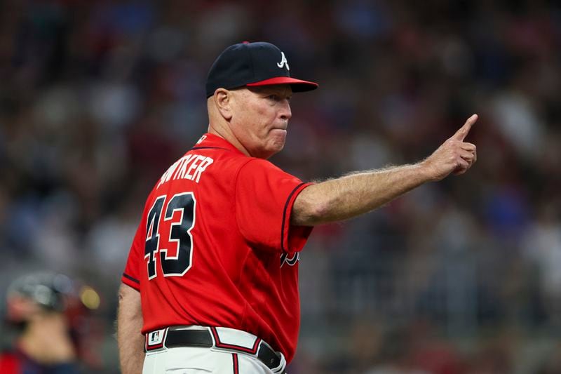 Atlanta Braves manager Brian Snitker signals to the bullpen for a pitching change during the seventh inning against the Philadelphia Phillies at Truist Park, Friday, May 26, 2023, in Atlanta. The Phillies won against the Braves 6-4. (Jason Getz / Jason.Getz@ajc.com)