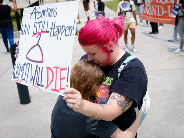 Macey Milstead and her son Zealand embrace during an abortion rights rally organized by Georgia Stand Up in front of the Georgia State Capitol on Friday, June 24, 2022. The rally follows the Supreme Court ruling overturning Roe v. Wade. (Arvin Temkar / arvin.temkar@ajc.com)