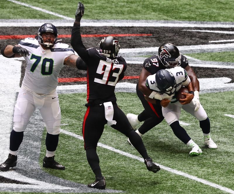 Falcons defensive tackle Grady Jarrett sacks Seattle Seahawks quarterback Russel Wilson during the first half Sunday, Sept. 13, 2020, in Atlanta. (Curtis Compton / Curtis.Compton@ajc.com)