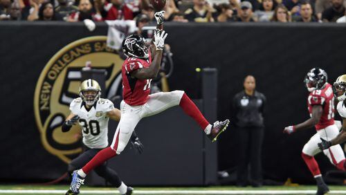 Atlanta Falcons wide receiver Mohamed Sanu (12) leaps for a pass against New Orleans Saints defensive back Erik Harris (30) in the first half of an NFL football game in New Orleans, Monday, Sept. 26, 2016. (AP Photo/Bill Feig)